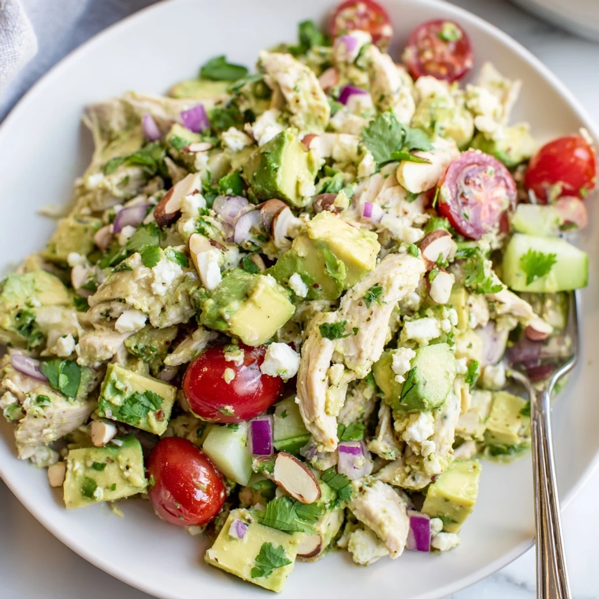 Creamy Avocado Chicken Salad tossed with lime dressing, tomatoes, crisp cucumber