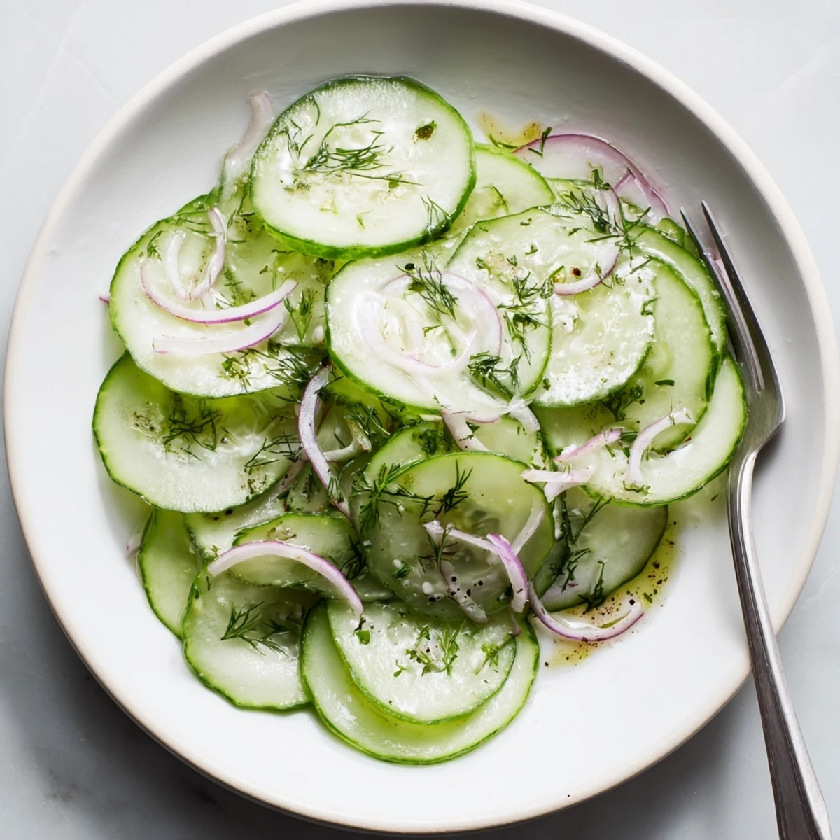 Bright Cucumber Salad tossed in tangy white wine vinegar dressing, refreshing crunch