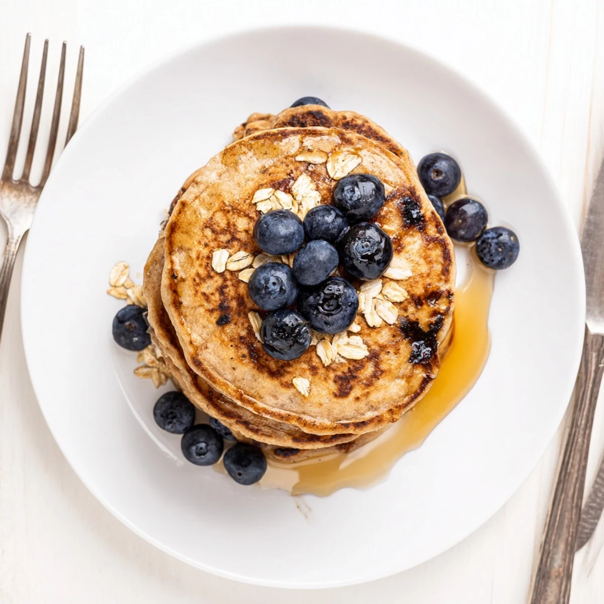 American breakfast skillet sizzling with protein banana pancakes topped with banana slices and walnuts