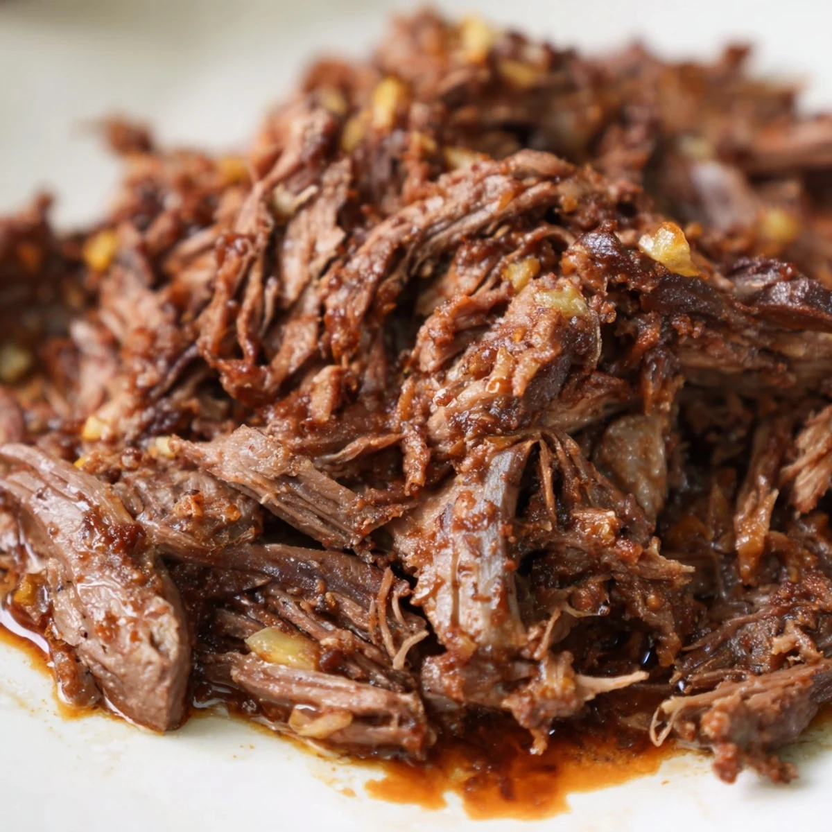 Juicy slow cooker beef barbacoa meat shredded perfectly, steaming and ready for taco night