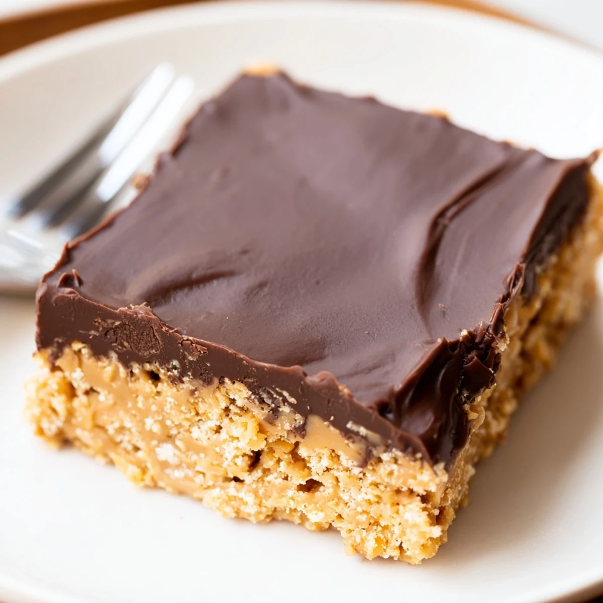 Homemade Peanut Butter Bars cut into squares, rich, nutty aroma and texture.