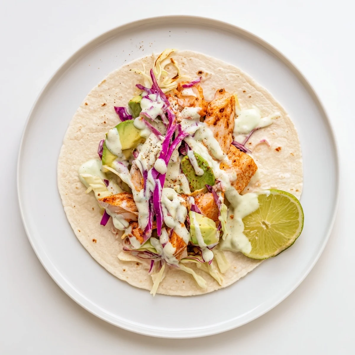 Warm Baked Cod Fish Tacos with Creamy Cilantro Lime Sauce, flaky fish