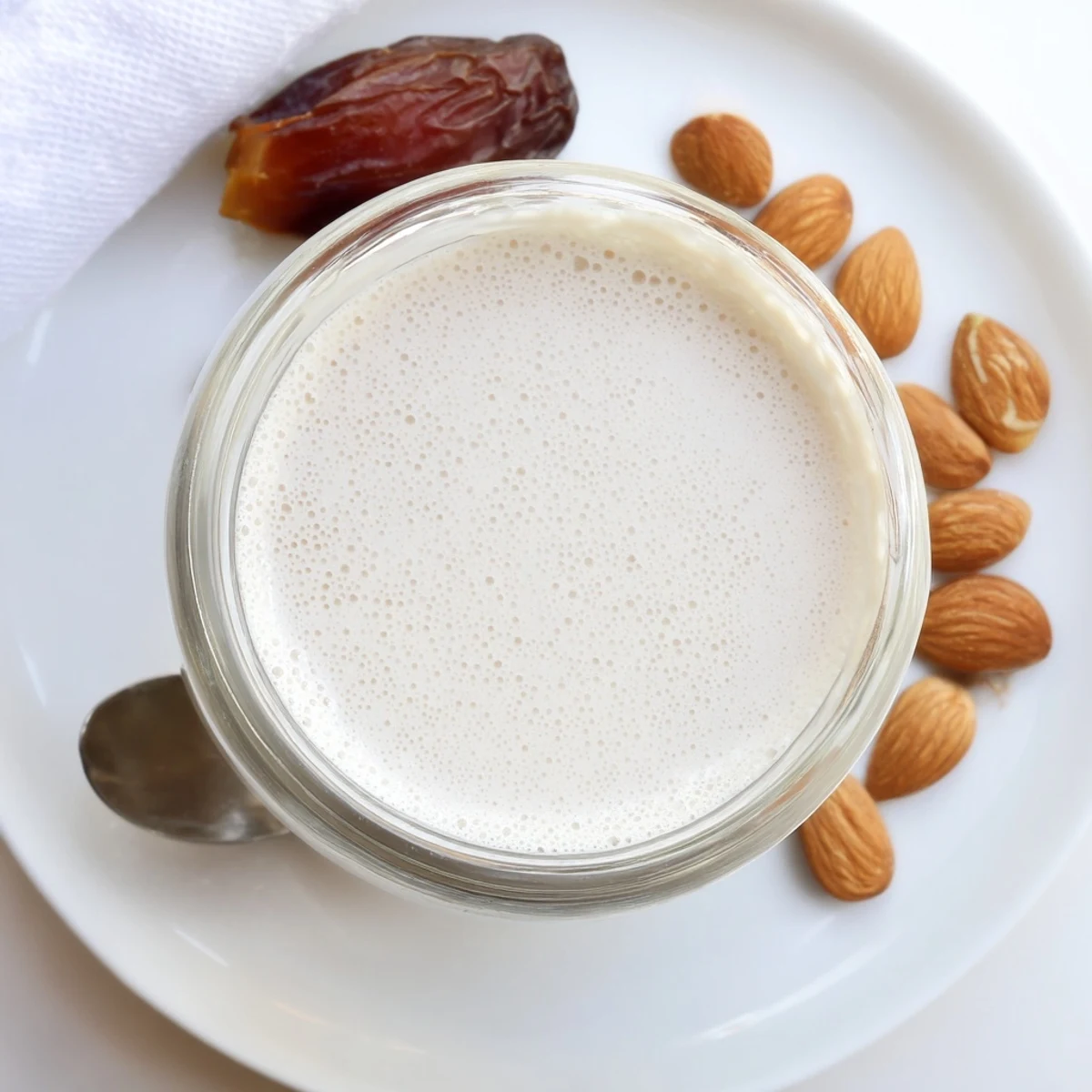 Velvety Almond Milk poured over cereal bowl, subtle vanilla aroma