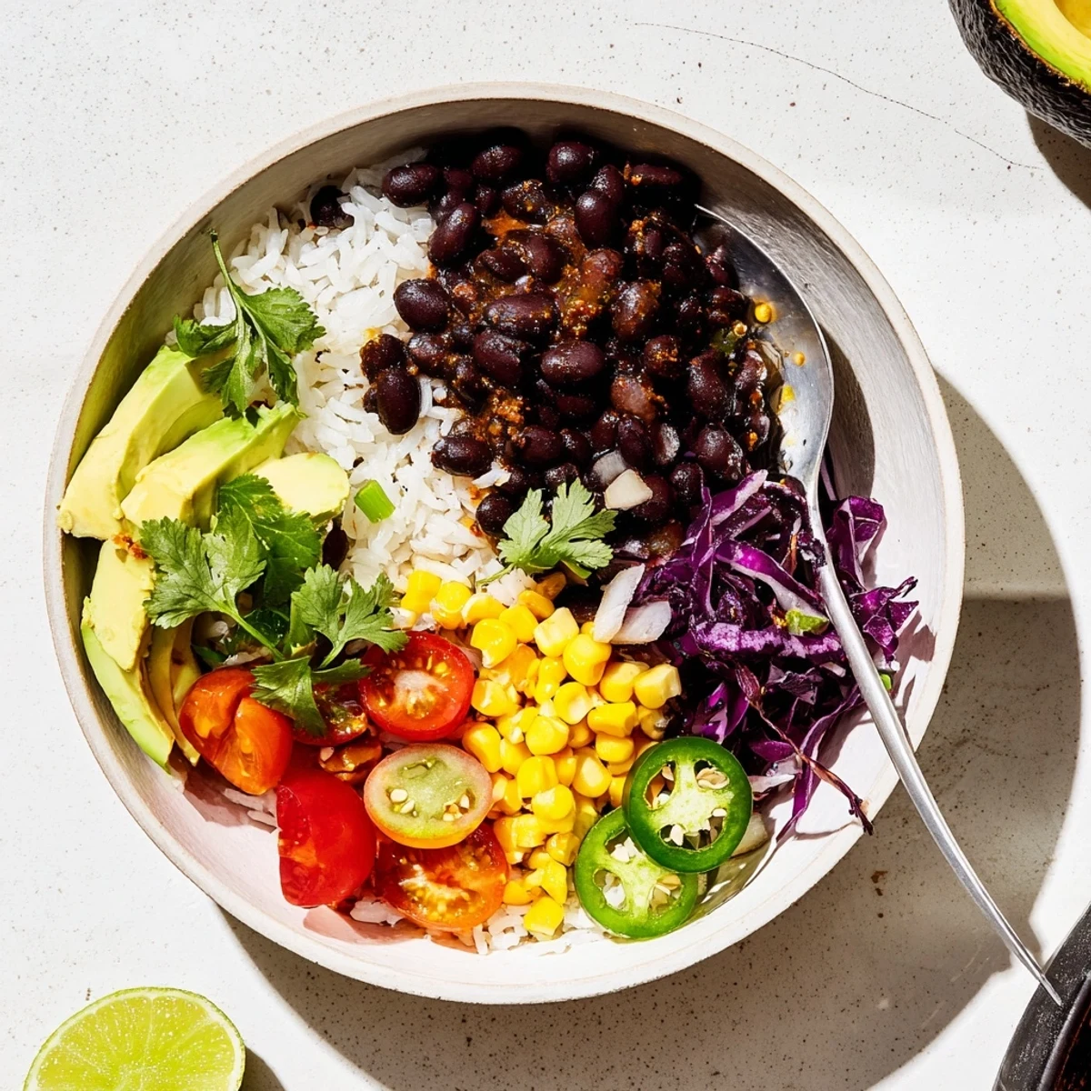 Hearty black bean and rice bowl drizzled with fresh lime juice and jalapeños