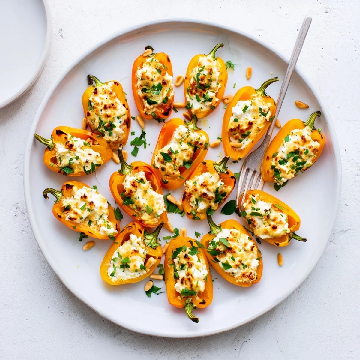 Creamy goat cheese filling bubbling inside charred sweet roasted mini pepper halves