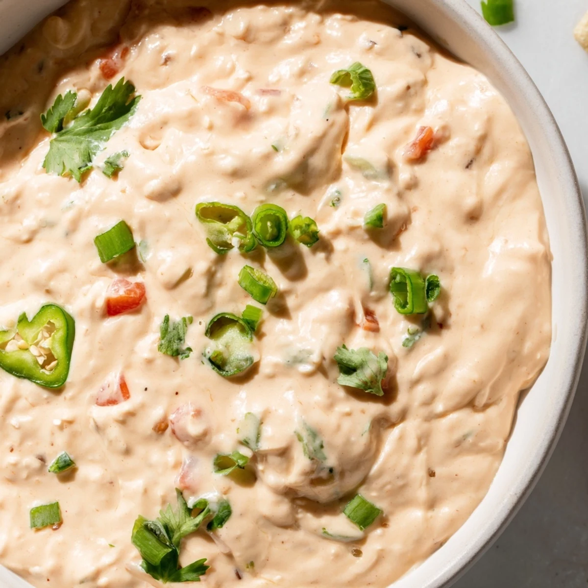 Creamy dairy-free Rotel nacho dip with diced tomatoes and green chilies, served warm with tortilla chips
