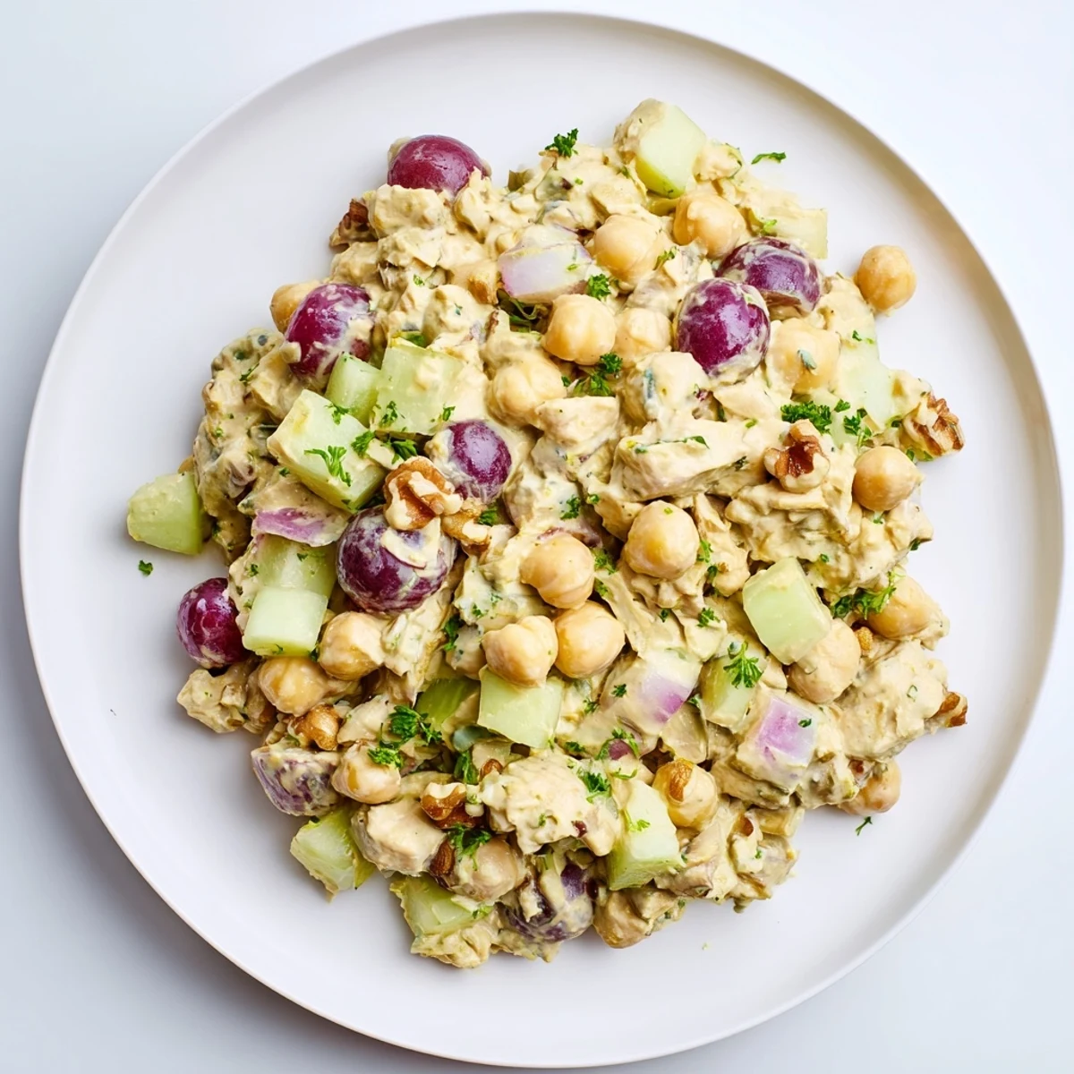 Hearty vegan chicken salad scooped into a fresh lettuce wrap with grapes
