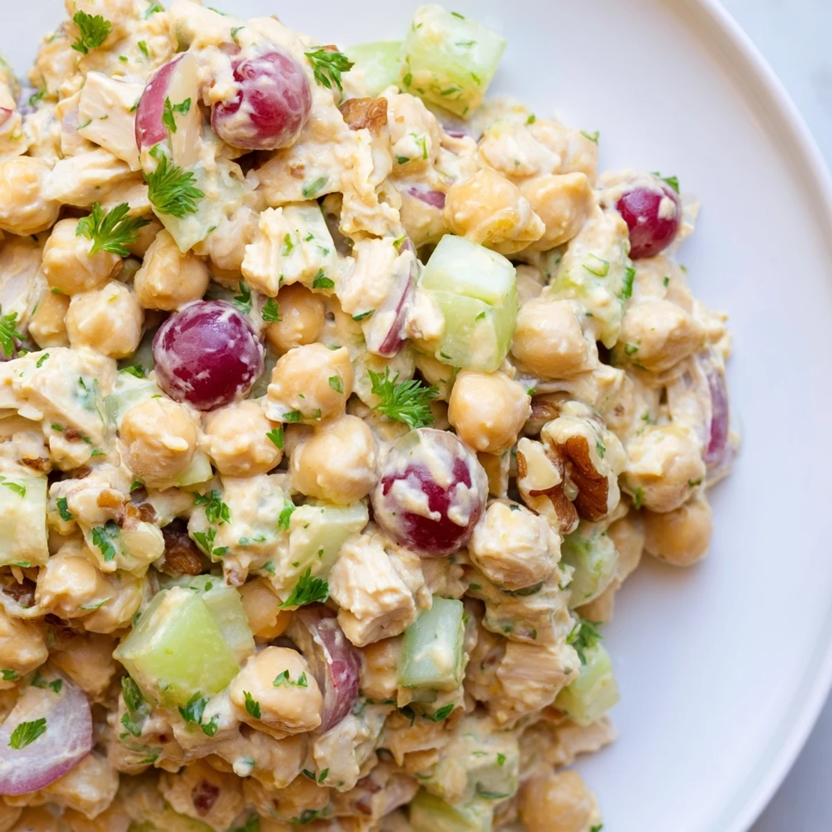 Creamy vegan chicken salad piled on toasted whole grain bread with crisp celery