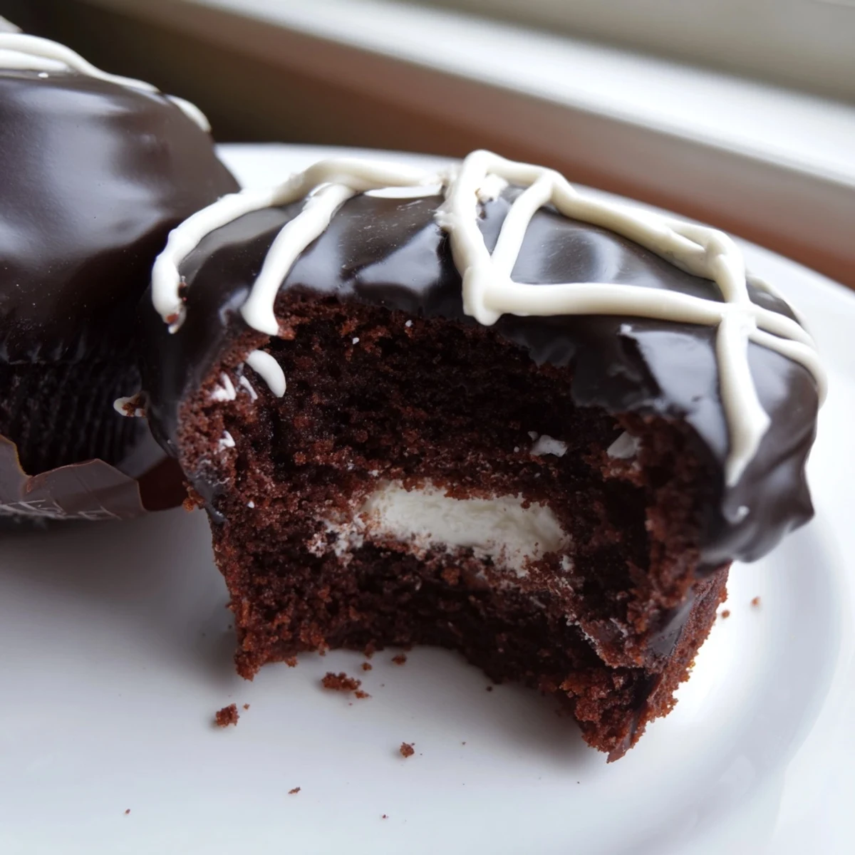 Rich Homemade Hostess Cupcakes featuring creamy centers and signature white icing swirls