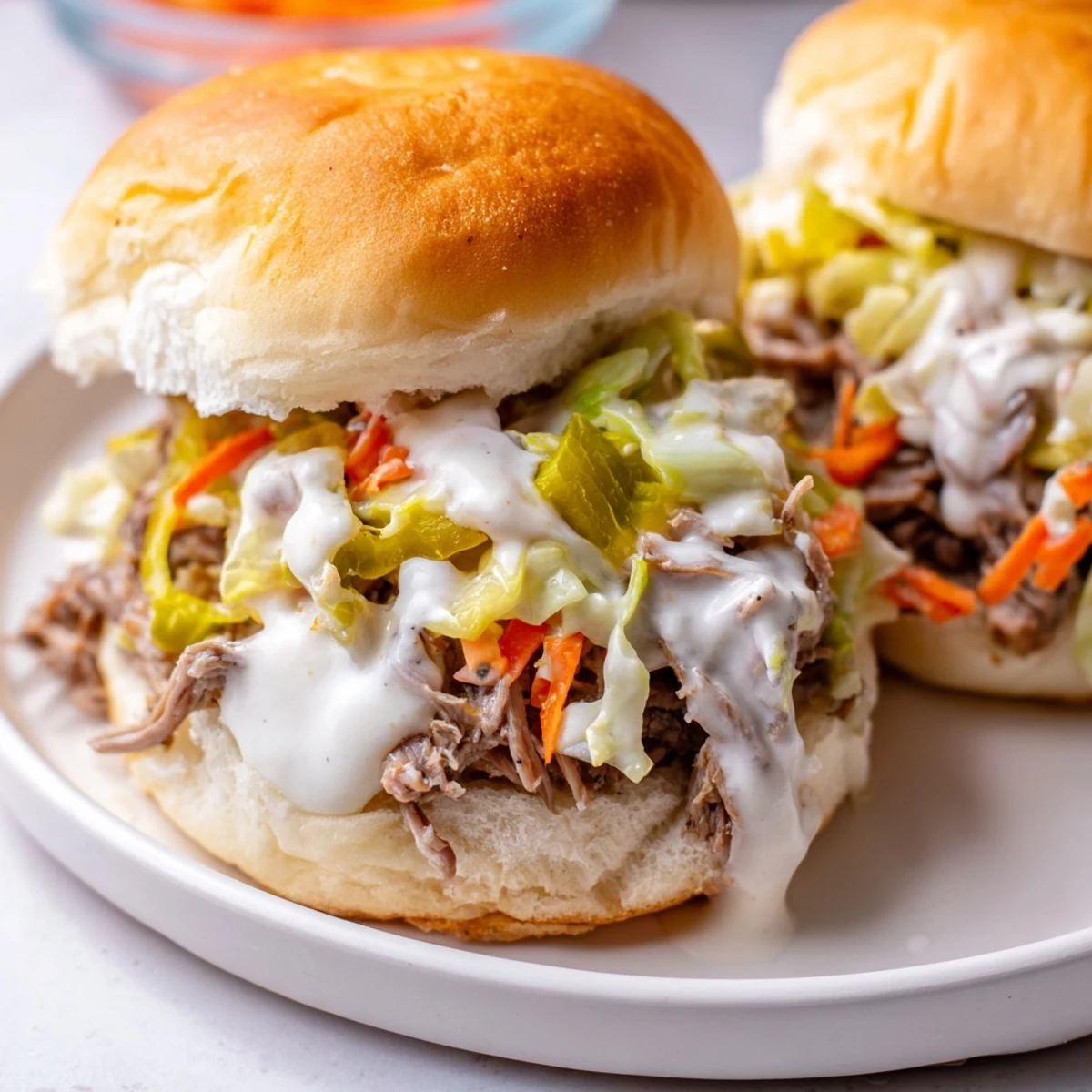 Juicy Alabama white sauce pulled lamb sliders piled on soft buns with crunchy slaw