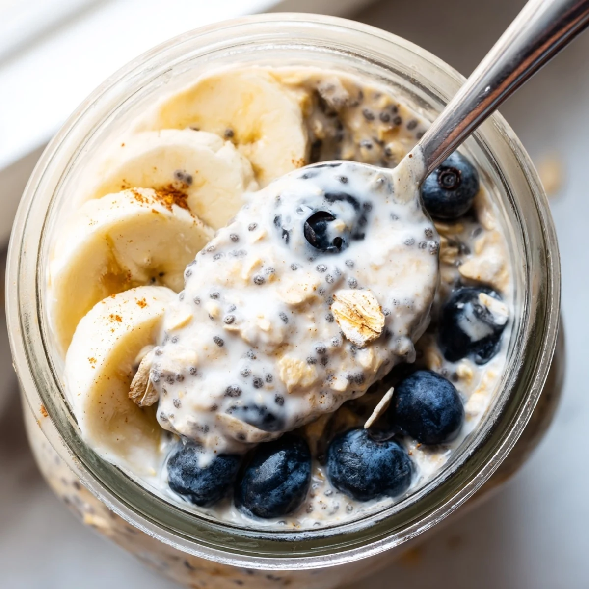 Chilled protein overnight oats served with Greek yogurt and a sprinkle of cinnamon