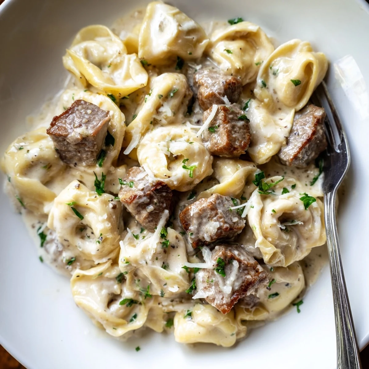 Golden seared steak bites nestled in cheesy garlic cream tortellini skillet