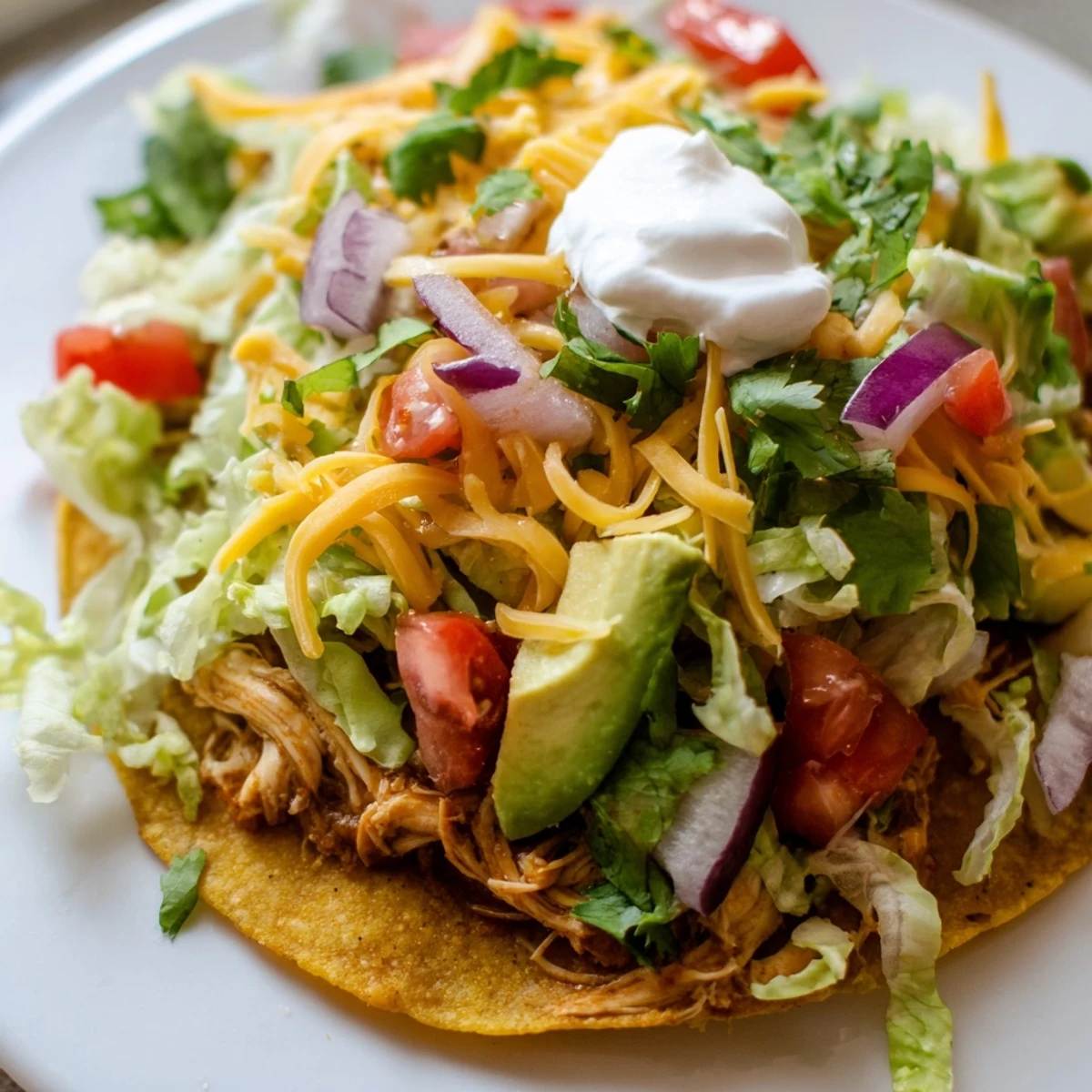 Golden Chicken Tostadas piled high with seasoned meat and colorful vegetables.  