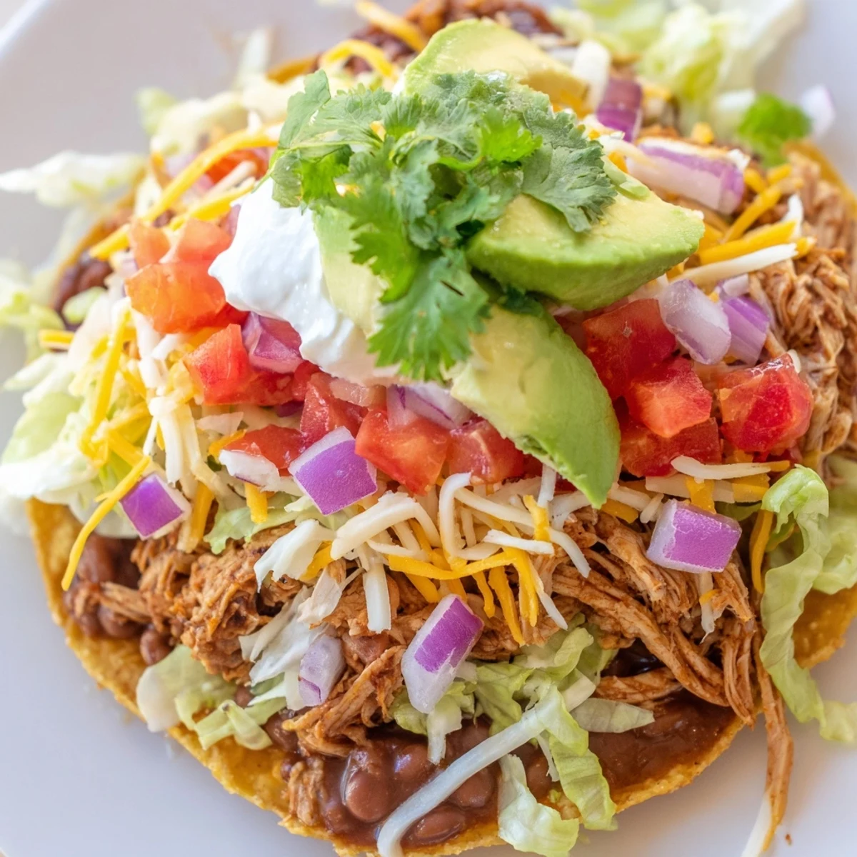 Delicious Mexican chicken tostadas served with fresh lime wedges and veggies