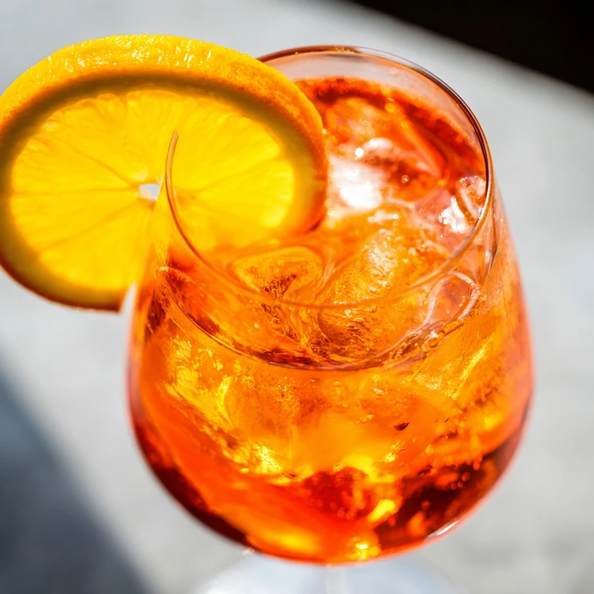 Chilled glass of Spritz topped with soda water and an olive.  