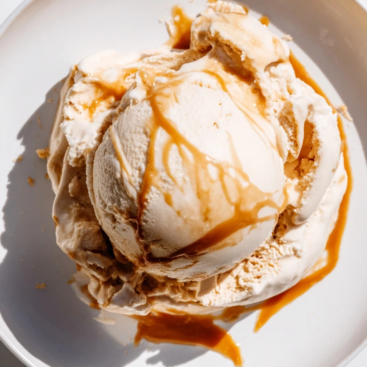 Rich salted caramel ice cream recipe garnished with extra caramel sauce for a sweet treat  