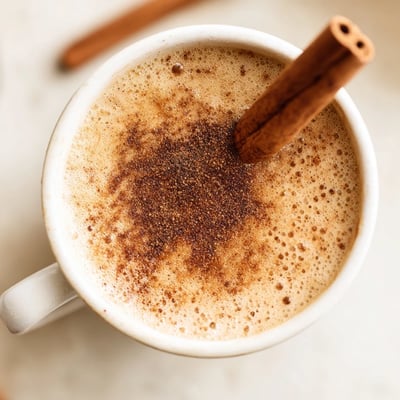 Homemade Spiced Chai Tea Latte with Cinnamon in a rustic mug, garnished with a cinnamon stick.