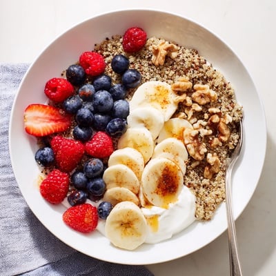 The Dietitians Balanced Breakfast Bowl features quinoa, banana slices, and walnuts arranged neatly in two ceramic bowls.